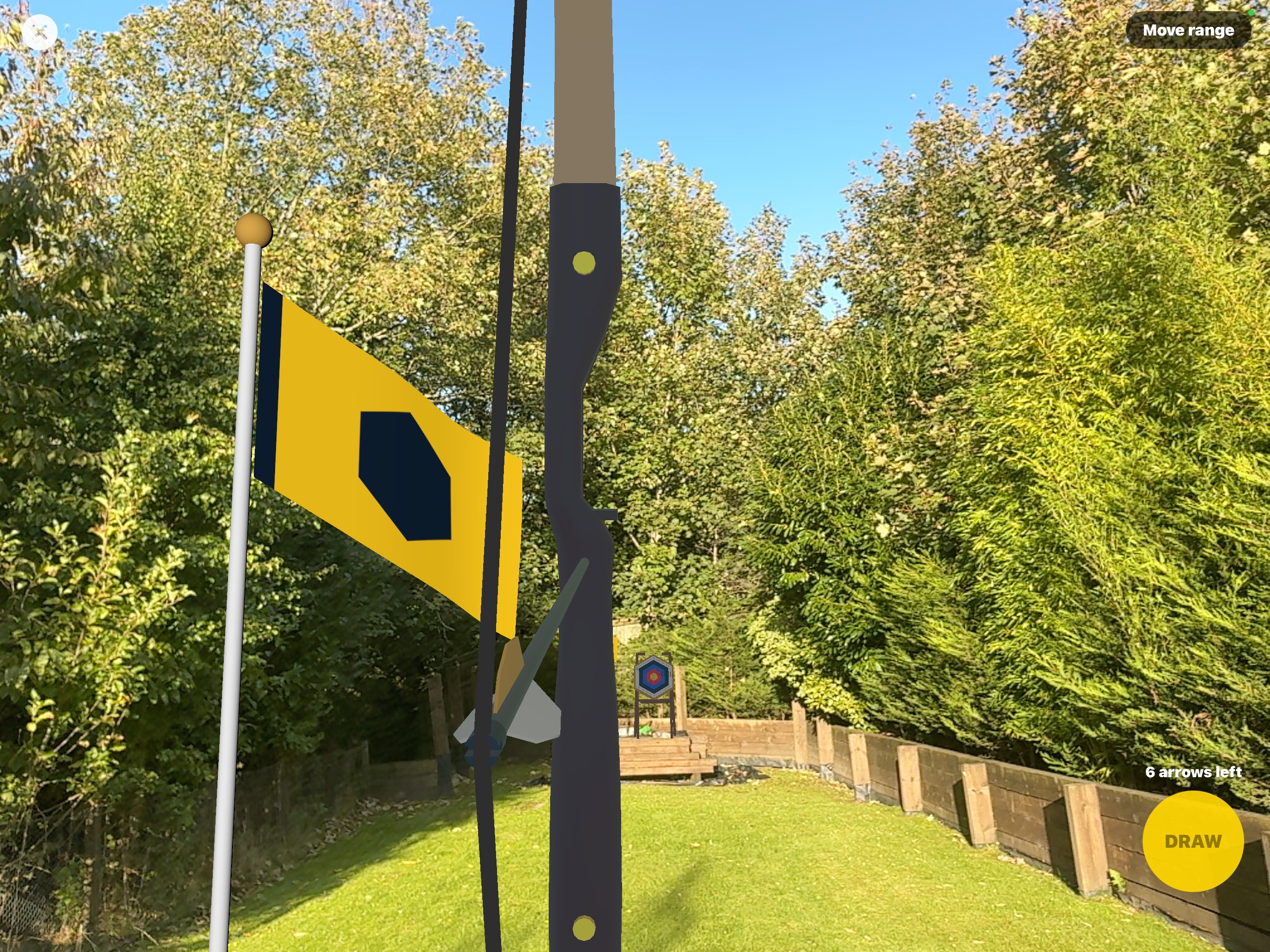 Hex Arrow in AR with a virtual bow and arrow, yellow wind flag and hexagonal target over a live garden camera view, plus Move range, six arrows left and the yellow DRAW button.